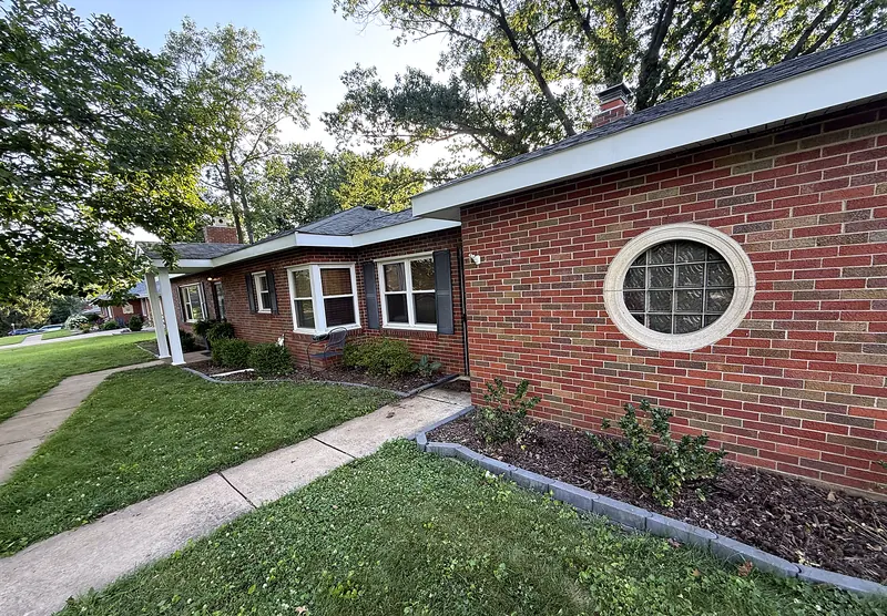 Brick ranch home with new white fascia, soffit and dark shingle roof
