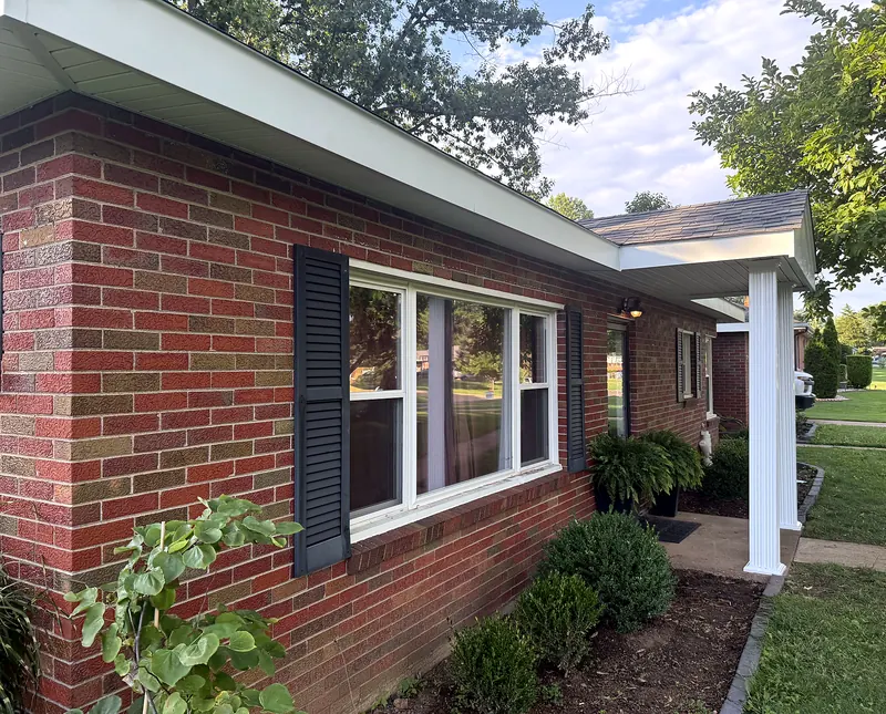 Brick home with new white fascia wrap leading to a new front porch