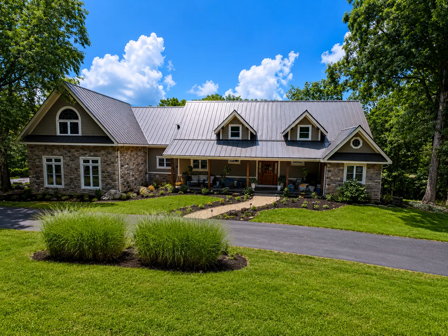 Stone and siding home with a new standing seam metal roof installed by Prime Time Exteriors in Southern Illinois